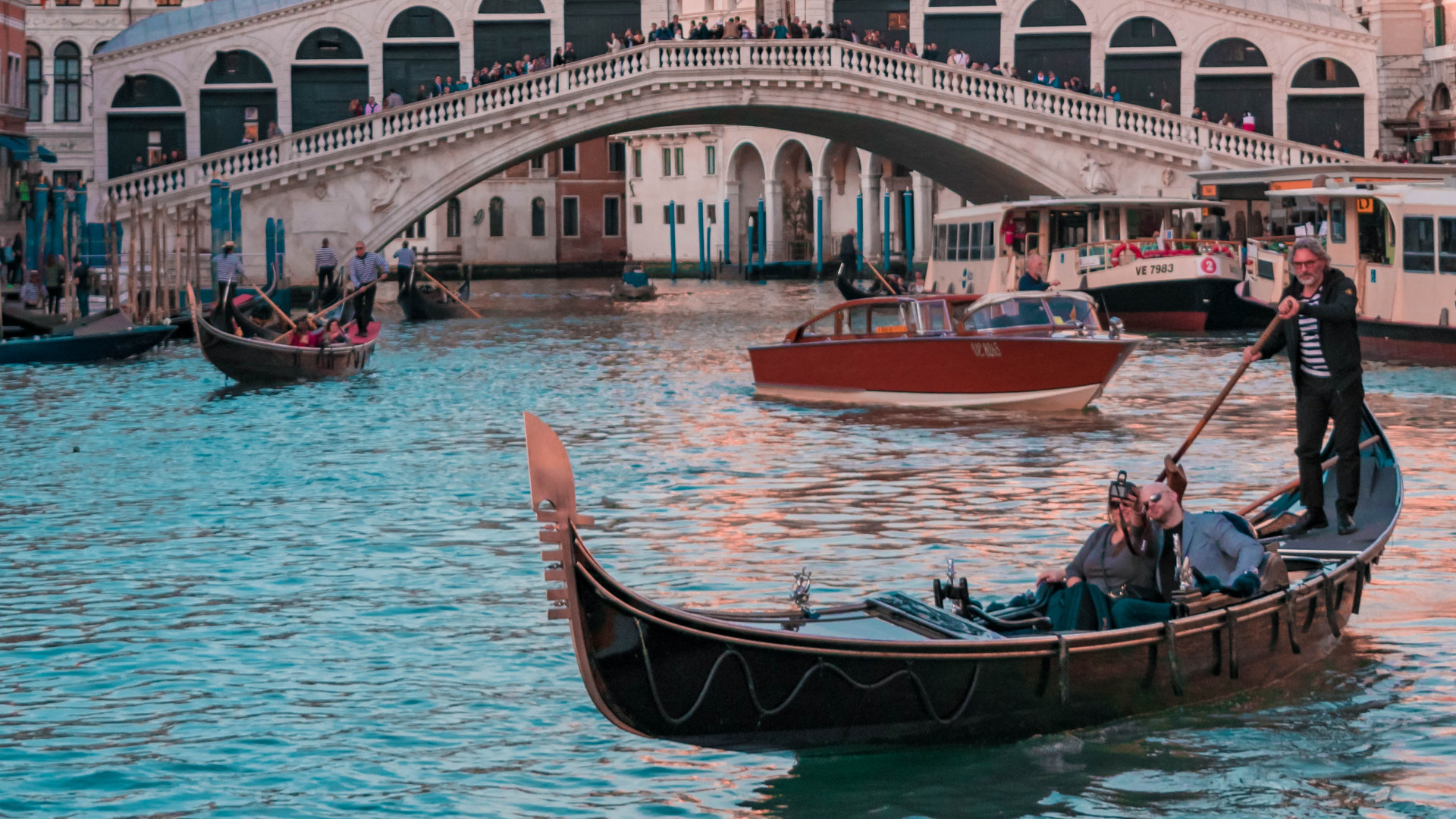 A couple of boats floating on top of water.