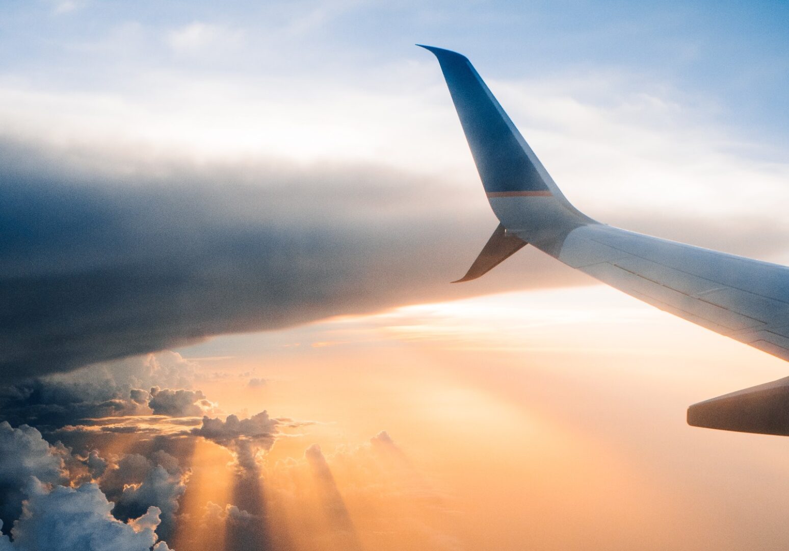 A view of the wing and the sun from an airplane.